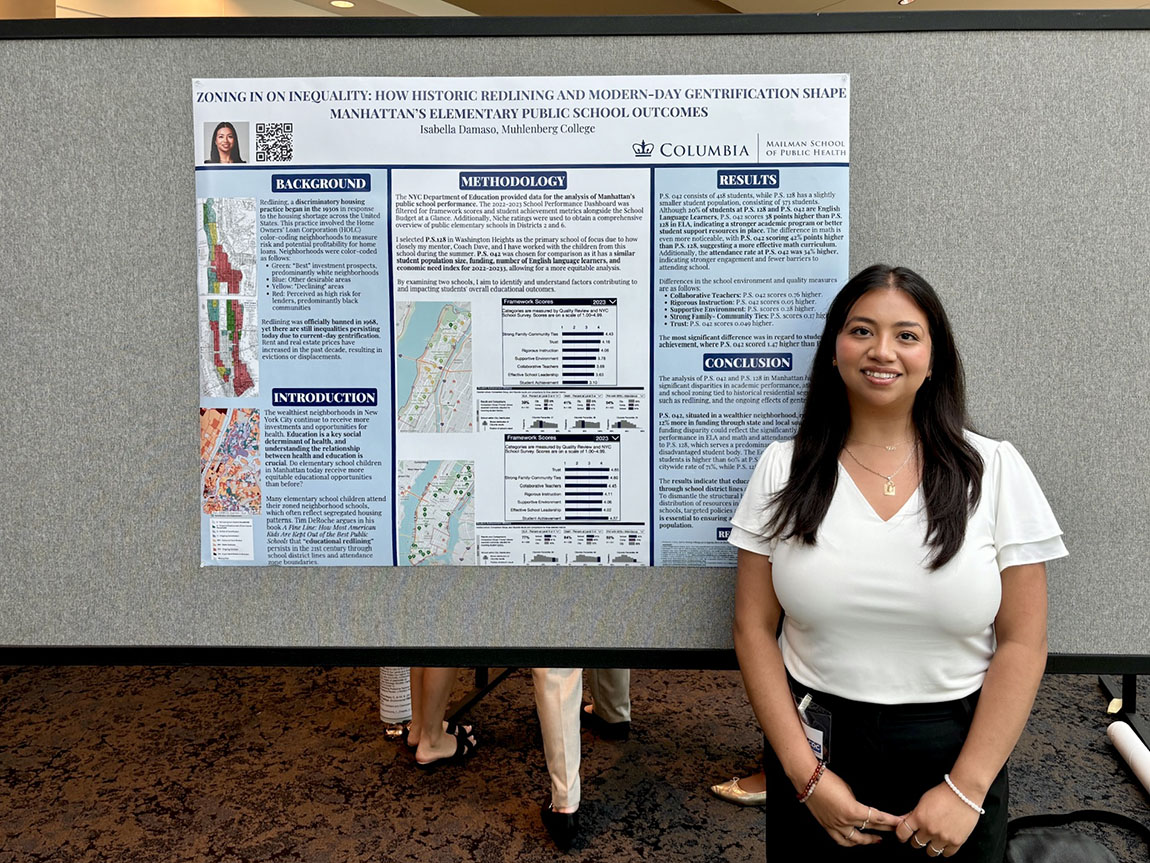 A college student stands in front of a research poster